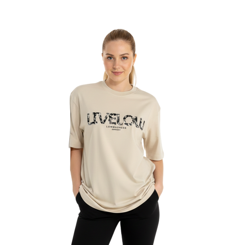 Oversized 220gsm heavyweight cotton graphic t-shirt in heather grey. Features a bold tri-color artistic streetwear design on the chest. Model is wearing a boxy fit, premium cotton tee with a modern drop-shoulder silhouette.
