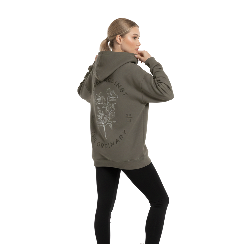 Oversized premium cotton 350GSM hoodie in grey. Front features an arched tonal logo, and the back shows a large floral graphic with "Rebel Against The Ordinary" text. Premium boxy fit streetwear for a structured silhouette.